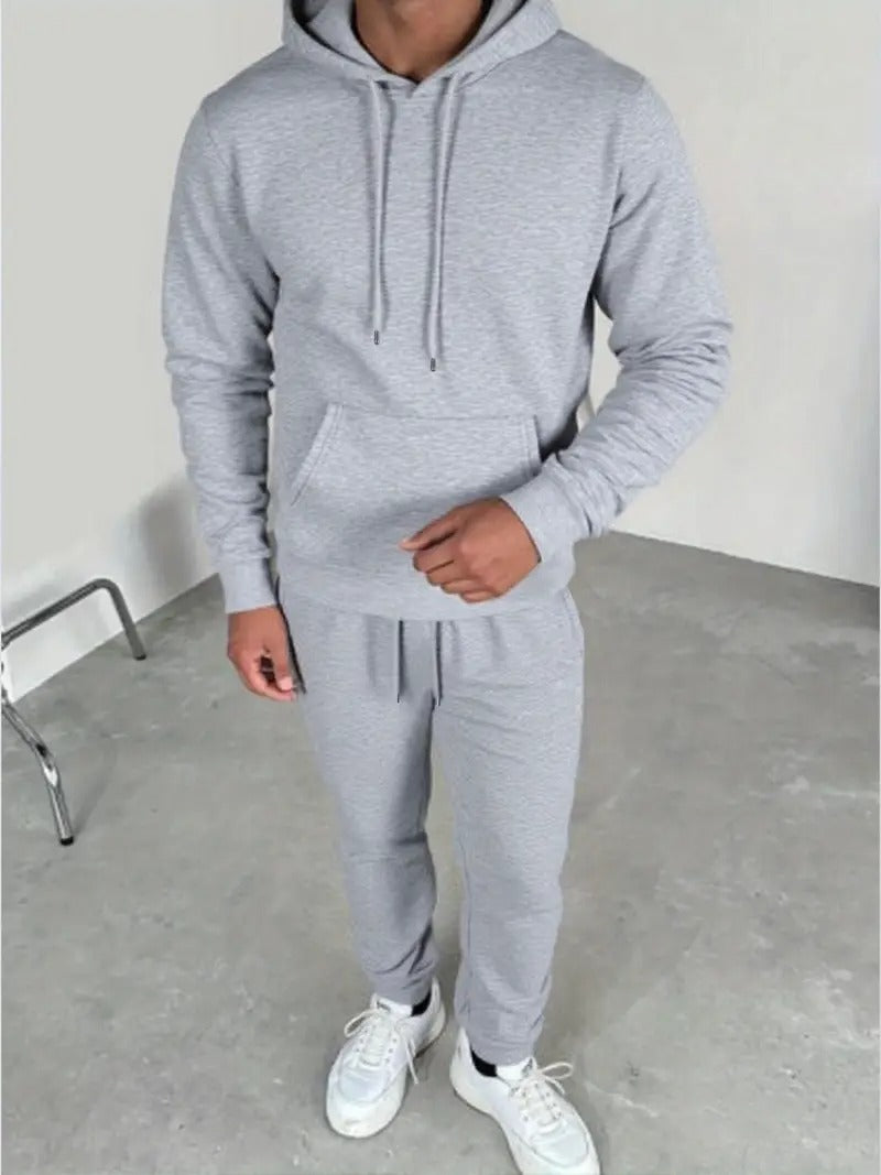 Person wearing a gray tracksuit with white sneakers in Pakistan